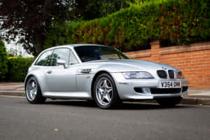 Bmw Z3 Roadster Cruising Down The Road Wallpaper