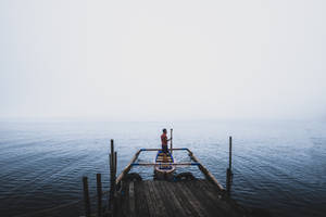 Boat Against Foggy Horizon Wallpaper