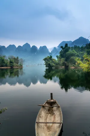 Boat On A Serene River Wallpaper