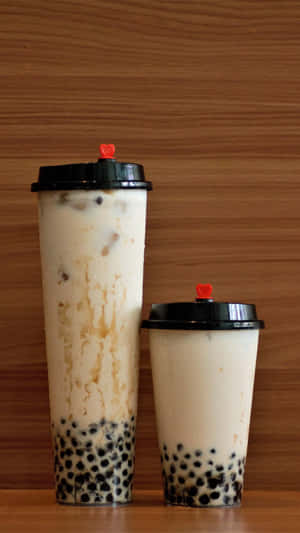 Boba Tea Coupleon Wooden Background Wallpaper