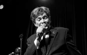 Bobby Caldwell Performing Live At A Concert Wallpaper