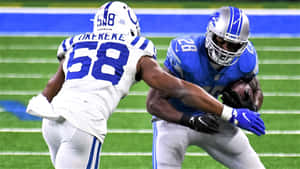 Bobby Okereke In Action On The Football Field Wallpaper