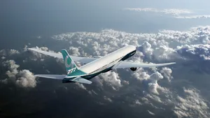 Boeing777 In Flight Over Clouds Wallpaper