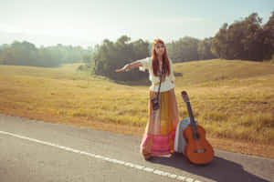 Boho Hippie Girl Hitchhiking With Guitar Wallpaper