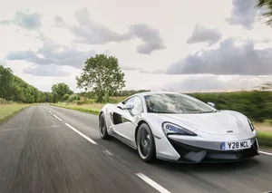 Bold Elegance: Mclaren 540c On The Road Wallpaper