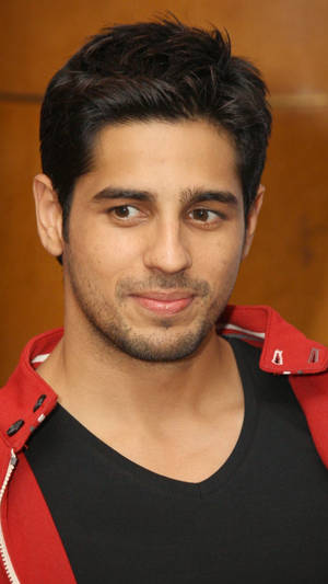 Bollywood Heartthrob Sidharth Malhotra In A Striking Red Jacket Wallpaper