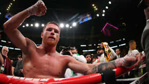 Boxing Champion Saul 'canelo' Alvarez Raising A Fist In Triumph Wallpaper