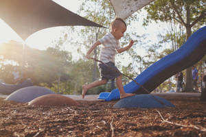 Boy On Playground Rocks Wallpaper