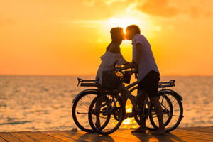 Boyfriend And Girlfriend Kisses And Bikes Wallpaper