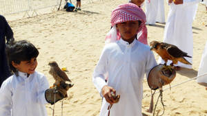 Boys Playing With Qatar's Falcon Wallpaper