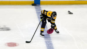 Brad Marchand Removing His Hat Off The Ice Wallpaper