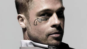 Brad Pitt Sporting A Gun Tattoo In His Eye Wallpaper