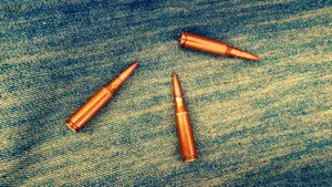 Brass Bullets On Denim Background Wallpaper