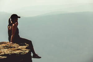 Brave Woman Scaling A Mountain Wallpaper