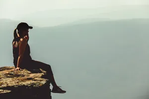 Brave Woman Scaling A Mountain Wallpaper
