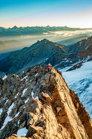 Bravely Exploring The Peaks Of The World Wallpaper