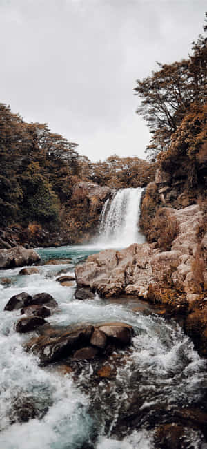 Breathe In The Beauty Of Nature With This Majestic Iphone Waterfall Wallpaper