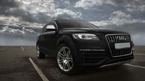 Breathtaking View Of A Sleek Audi Q7 On A Scenic Mountain Road. Wallpaper