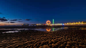 Breathtaking View Of Blackpool Tower Alongside Central Pier Big Wheel Wallpaper