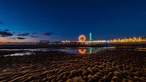 Breathtaking View Of Blackpool Tower Alongside Central Pier Big Wheel Wallpaper