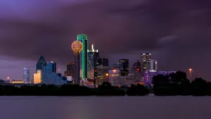 Breathtaking View Of Dallas Skyline Under Dark Clouds Wallpaper
