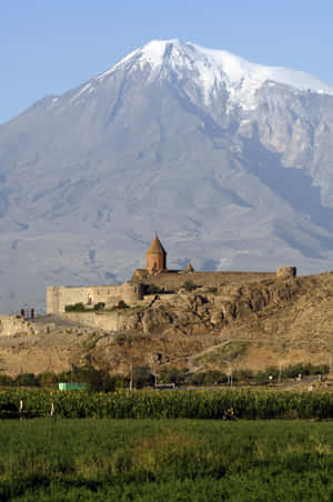 Breathtaking View Of Khor Virap Monastery Against Majestic Mountains Wallpaper