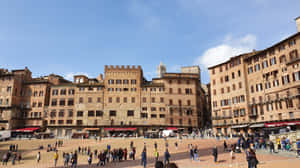 Brick Buildings At Piazza Del Campo In Siena Wallpaper