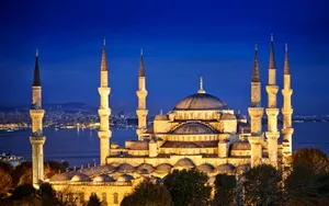 Bright Blue Mosque In Night Sky Wallpaper