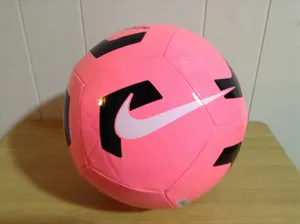 Bright Pink Soccer Ball On Vibrant Green Grass Wallpaper