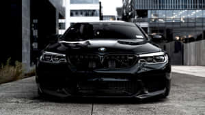 Bright Red Bmw Sedan Parked On The Side Of The Road Wallpaper