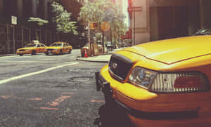 Bright Yellow Cab In The City Wallpaper