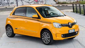 Bright Yellow Renault Twingo Urban Backdrop Wallpaper