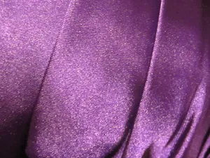 Brighten Up Any Space With The Shimmering Color Of Purple Satin Wallpaper