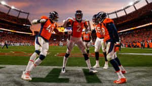 Broncos Players Celebratingon Field Wallpaper