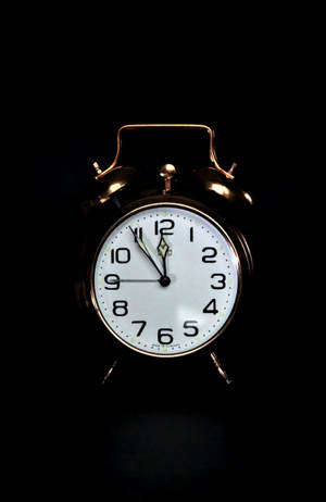 Bronze Clock On Black Backdrop Wallpaper