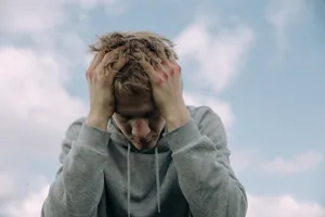 Bruised Man Holding Head Wallpaper