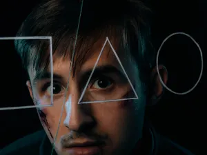 Bruised Man Looking Through Triangle Wallpaper