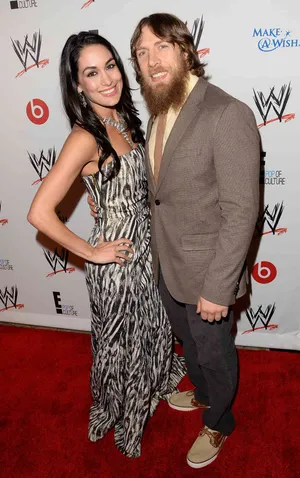 Bryan Danielson And Brie Bella Striking A Pose Together Wallpaper