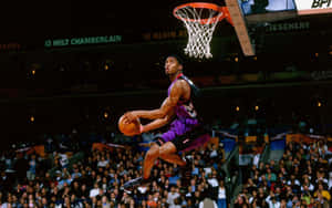 Bryan Mcgrady Flying Through The Air In A Slam Dunk Wallpaper