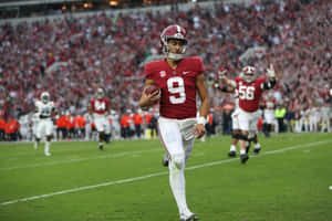 Bryce Young In Action At Football Game Wallpaper