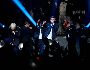 Bts Live: Energetic Performance On A Stellar Stage Wallpaper