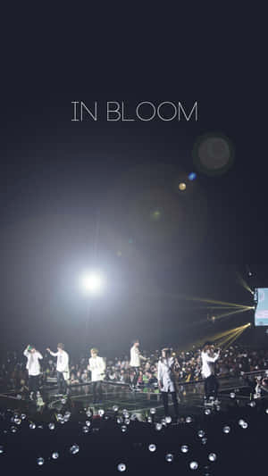 Bts Performing On Stage At A Concert Wallpaper