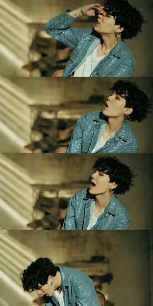 Bts Performs In Their Music Video, Captivating The Audience With Vibrant Colors And Dynamic Presence Wallpaper