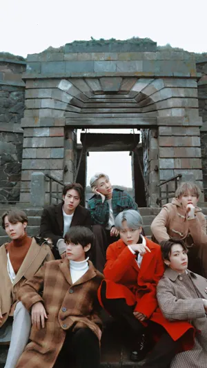 Bts Photoshoot Sitting On Stone Staircase Wallpaper