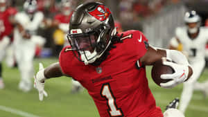 Buccaneers Player Running With Football Wallpaper