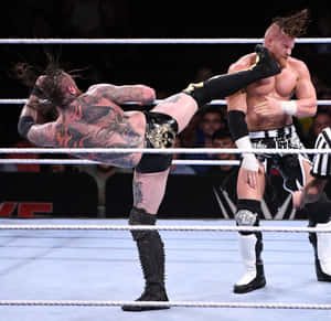 Buddy Murphy Kicked By Aleister Black Wwe Tlc 2019 Wallpaper