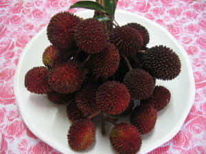 Bunch Of Pulasan Fruits On Plate Wallpaper