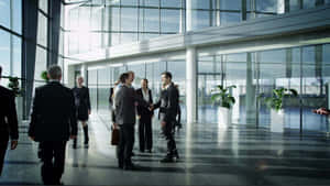 Business Professionals Meetingin Modern Office Lobby.jpg Wallpaper