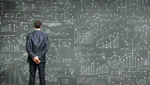 Businessman Analyzing Complex Data Chalkboard Wallpaper