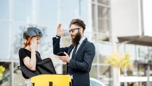 Businessmanand Delivery Girl Discussion Outdoors Wallpaper